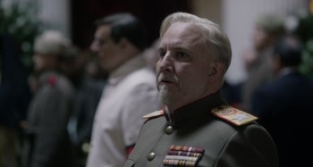 Movie still from “The Death of Stalin” (2017), directed by Armando Iannucci – A man in a military uniform is looking to his left; Close Up shot, Over the shoulder angle
