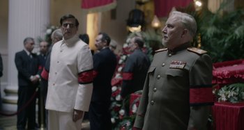Movie still from “The Death of Stalin” (2017), directed by Armando Iannucci – A group of men standing next to each other in a room; Medium shot, Over the shoulder angle