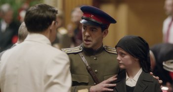 Movie still from “The Death of Stalin” (2017), directed by Armando Iannucci – A man in a military uniform talking to two people; Close Up shot, Over the shoulder angle