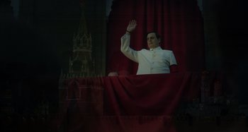 Movie still from “The Death of Stalin” (2017), directed by Armando Iannucci – A man in a white suit waves to the crowd; Medium shot, Low angle
