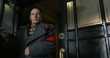Movie still from “The Death of Stalin” (2017), directed by Armando Iannucci – A man in a military uniform standing in front of a door; Medium shot, Low angle