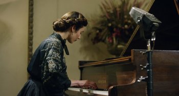 Movie still from “The Death of Stalin” (2017), directed by Armando Iannucci – A woman in a black dress playing a piano; Medium shot, High angle
