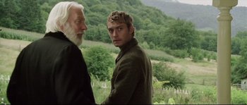 Movie still from “Cold Mountain” (2003), directed by Anthony Minghella – A man standing next to another man in a field; Medium shot, Over the shoulder angle