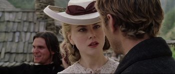 Movie still from “Cold Mountain” (2003), directed by Anthony Minghella – A woman wearing a white cowboy hat talking to a man wearing a white cowboy hat; Close Up shot, Over the shoulder angle