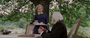 Movie still from “Cold Mountain” (2003), directed by Anthony Minghella – An older man and a young woman holding a tray of food; Medium shot, Over the shoulder angle