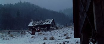 Movie still from “Cold Mountain” (2003), directed by Anthony Minghella – An old log cabin in the middle of a snow covered field; Extreme Wide shot, Low angle