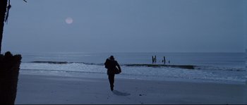 Movie still from “Cold Mountain” (2003), directed by Anthony Minghella – A man walking on the beach at night; Extreme Wide shot, High angle