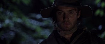 Movie still from “Cold Mountain” (2003), directed by Anthony Minghella – A person wearing a hat and looking at the camera; Close Up shot, Over the shoulder angle