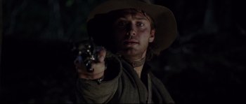 Movie still from “Cold Mountain” (2003), directed by Anthony Minghella – A man holding a gun while standing in the dark; Close Up shot, Low angle