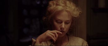 Movie still from “Cold Mountain” (2003), directed by Anthony Minghella – A woman with curly blonde hair is looking down; Close Up shot, Over the shoulder angle