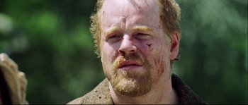 Movie still from “Cold Mountain” (2003), directed by Anthony Minghella – A person with bruises on his face; Close Up shot, Over the shoulder angle