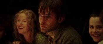 Movie still from “Cold Mountain” (2003), directed by Anthony Minghella – A person wearing a neck scarf; Close Up shot, Over the shoulder angle