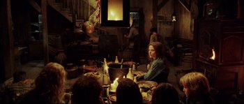 Movie still from “Cold Mountain” (2003), directed by Anthony Minghella – A group of people sitting around a dinner table; Wide shot, Over the shoulder angle