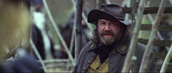 Movie still from “Cold Mountain” (2003), directed by Anthony Minghella – A man with a long beard wearing a hat; Close Up shot, Low angle