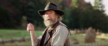 Movie still from “Cold Mountain” (2003), directed by Anthony Minghella – An old man with a long beard wearing a hat and holding a stick; Close Up shot, Low angle
