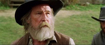 Movie still from “Cold Mountain” (2003), directed by Anthony Minghella – An old man with a long white beard wearing a cowboy hat; Close Up shot, Low angle