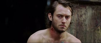 Movie still from “Cold Mountain” (2003), directed by Anthony Minghella – A person with a scar on his face; Close Up shot, Over the shoulder angle