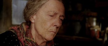 Movie still from “Cold Mountain” (2003), directed by Anthony Minghella – An older woman with a sad look on her face; Close Up shot, High angle