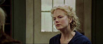 Movie still from “Cold Mountain” (2003), directed by Anthony Minghella – A woman with blonde curly hair is looking to her left; Close Up shot, Over the shoulder angle