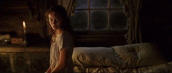 Movie still from “Cold Mountain” (2003), directed by Anthony Minghella – A woman standing next to a bed in front of a window; Medium shot, Low angle
