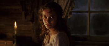 Movie still from “Cold Mountain” (2003), directed by Anthony Minghella – A woman with long curly brown hair wearing a white shirt; Close Up shot, Over the shoulder angle