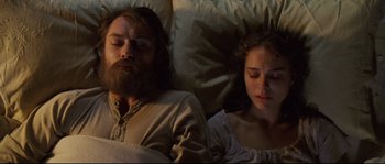 Movie still from “Cold Mountain” (2003), directed by Anthony Minghella – A man and a woman laying in a bed together; Close Up shot, High angle