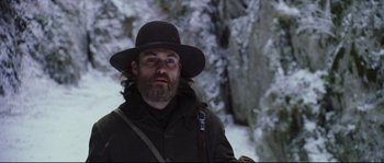 Movie still from “Cold Mountain” (2003), directed by Anthony Minghella – A man with a beard wearing a black hat; Close Up shot, Low angle