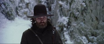 Movie still from “Cold Mountain” (2003), directed by Anthony Minghella – A man with a beard wearing a black hat; Close Up shot, Low angle