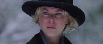 Movie still from “Cold Mountain” (2003), directed by Anthony Minghella – A person wearing a black hat; Close Up shot, Over the shoulder angle