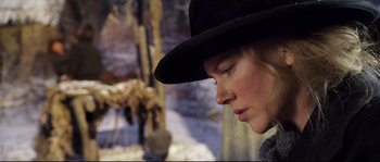 Movie still from “Cold Mountain” (2003), directed by Anthony Minghella – A woman wearing a black hat looking to the side; Close Up shot, Low angle