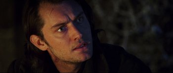 Movie still from “Cold Mountain” (2003), directed by Anthony Minghella – A man's face in the dark; Close Up shot, Over the shoulder angle