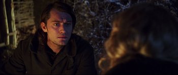 Movie still from “Cold Mountain” (2003), directed by Anthony Minghella – A man and a woman sitting in front of each other in the dark; Close Up shot, Over the shoulder angle