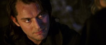 Movie still from “Cold Mountain” (2003), directed by Anthony Minghella – A man's face in the dark; Close Up shot, Over the shoulder angle