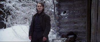 Movie still from “Cold Mountain” (2003), directed by Anthony Minghella – A man standing in front of a stone wall; Medium shot, Low angle