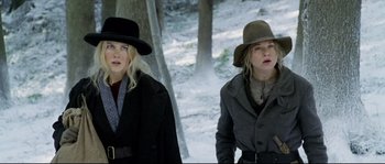 Movie still from “Cold Mountain” (2003), directed by Anthony Minghella – Two women in hats and coats walking in the snow; Medium shot, Low angle