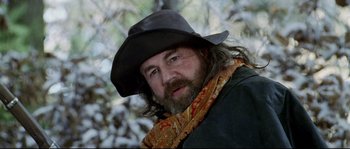 Movie still from “Cold Mountain” (2003), directed by Anthony Minghella – A man with a beard wearing a black hat; Close Up shot, Low angle