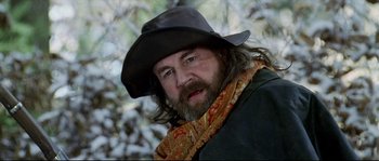 Movie still from “Cold Mountain” (2003), directed by Anthony Minghella – A man with a long beard wearing a black hat; Close Up shot, Low angle