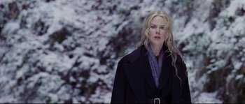Movie still from “Cold Mountain” (2003), directed by Anthony Minghella – A woman with long blonde hair wearing a black coat; Medium shot, Over the shoulder angle