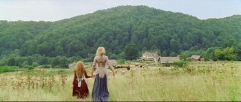 Movie still from “Cold Mountain” (2003), directed by Anthony Minghella – Two people holding hands while walking through a field; Wide shot, Low angle