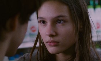Movie still from “Cold Water” (1994), directed by Olivier Assayas – A person with long brown hair; Close Up shot, Over the shoulder angle