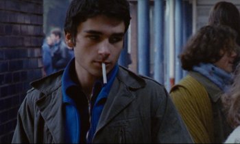Movie still from “Cold Water” (1994), directed by Olivier Assayas – A man with a cigarette in his mouth; Close Up shot, Over the shoulder angle
