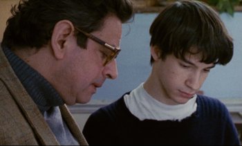 Movie still from “Cold Water” (1994), directed by Olivier Assayas – A man and a young boy looking at each other; Close Up shot, Over the shoulder angle