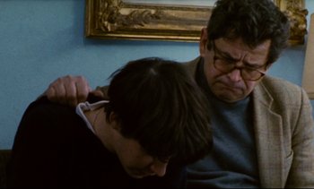 Movie still from “Cold Water” (1994), directed by Olivier Assayas – An older man and a younger man in a room; Close Up shot, Over the shoulder angle