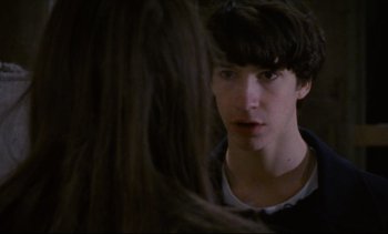 Movie still from “Cold Water” (1994), directed by Olivier Assayas – A young man looking into a mirror while standing next to a woman; Close Up shot, Over the shoulder angle