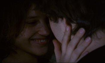 Movie still from “Cold Water” (1994), directed by Olivier Assayas – A person holding another person's face; Extreme Close Up shot, Over the shoulder angle