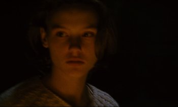 Movie still from “Cold Water” (1994), directed by Olivier Assayas – A young man with long dark hair stares at the camera; Close Up shot, Low angle