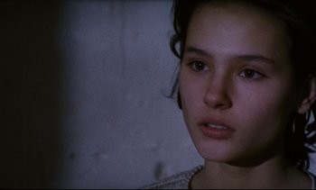 Movie still from “Cold Water” (1994), directed by Olivier Assayas – A young woman is looking into the camera; Close Up shot, High angle