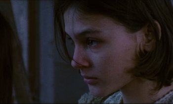Movie still from “Cold Water” (1994), directed by Olivier Assayas – A young woman with a sad look on her face; Close Up shot, Over the shoulder angle