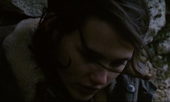 Movie still from “Cold Water” (1994), directed by Olivier Assayas – A person's face in the dark; Extreme Close Up shot, High angle