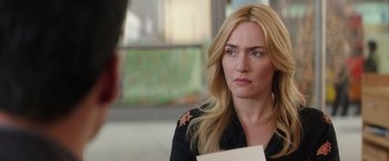 Movie still from “Collateral Beauty” (2016), directed by David Frankel – A woman with long blonde hair is holding a piece of paper; Close Up shot, Over the shoulder angle